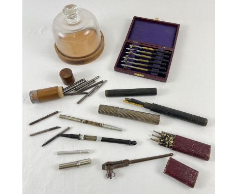A collection of vintage watch makers tools. To include a glass domed topped parts container, blades, screwdrivers and punches