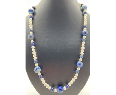 A 25" freshwater pearl and lapis lazuli beaded necklace with silver tone S shaped clasp. Retired jewellery makers stock. 