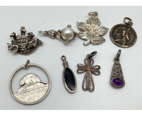 8 silver and white metal pendants/charms to include Noah's Ark, bird claw holding a faux pearl, Celtic design set with amethy