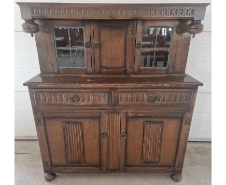 A mid century CWS Ltd dark wood court cupboard. 2 door cupboard to base with interior shelf and 2 drawers above; 1 a baize li