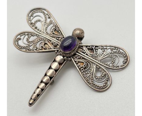A vintage silver filigree brooch in the shape of a dragonfly, with central oval amethyst cabochon. Marked 925 to back. Approx