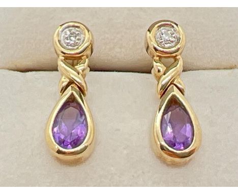 A pair of modern design 9ct gold amethyst and diamond set drop style earrings. Each set with a small round cut diamond and a 