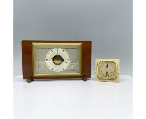 An Airguide barometer and thermometer elegantly encased in wood, alongside a Taylor Humidiguide housed in a plastic case with