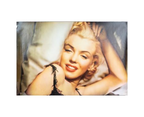 High quality poster print with full color and matte finish on paper. Features Marilyn Monroe lying in a satin covered bed wit