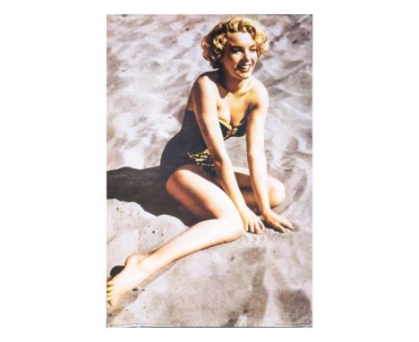 High quality poster print with full color and matte finish. Features Marilyn Monroe seated on a sandy beach modeling a beauti