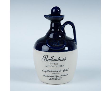 Empty ceramic scotch bottle and stoper decorated with cobalt blue glaze over clear glazed ceramic. Dimensions: 8.5"H x 4.75" 