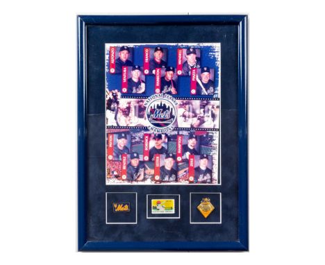 Framed image of the Mets 2000 National League Champion team. Mounted on lower border are two enamel pins and one USPS stamp. 