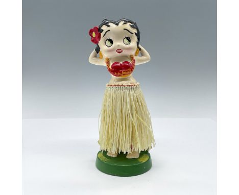 This hand-painted ceramic figurine captures Betty Boop in a charming pose, wearing a straw skirt that adds a touch of whimsy.