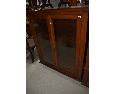 A mahogany cased glazed book shelf having rolled plate glass doors