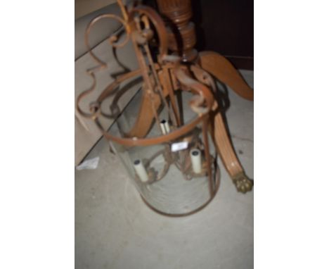A traditional candle style light fitting with part glass shade
