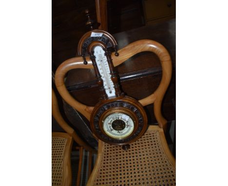 A small banjo style barometer with enamel face dial