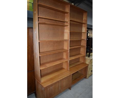 A vintage part pine tapered bookshelf , having cupboard and open shelf to base, height approx 240cm, width 183cm
Top does com