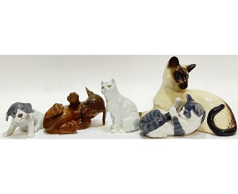 A group of ceramic animal figures comprising a Royal Doulton cat (h- 12cm, w- 19cm), three Royal Copenhagen figures (two pupp