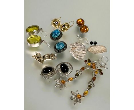 A collection of eight pairs of earrings to include a pair of silver oval faceted yellow stone earrings L x 2.2cm, a pair of s