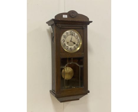 An early 20th century oak cased Vienna type wall clock, with silvered dial and Arabic chapter ring, eight day twin train move