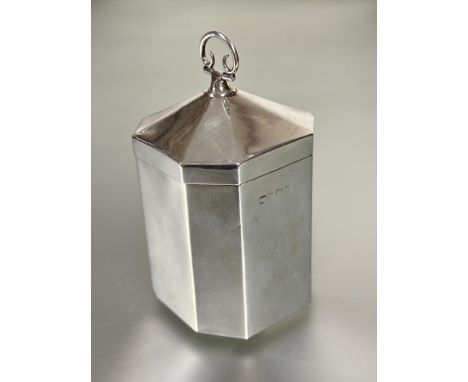 A Edwardian Birmingham silver octagonal panel sided and domed top tea caddy with scrolling loop hinged handle to top H x 10cm