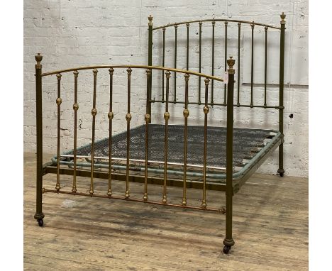 An Edwardian brass and green lacquered double bed frame, with urn finials, sprung base and moving on ceramic castors. H150cm,