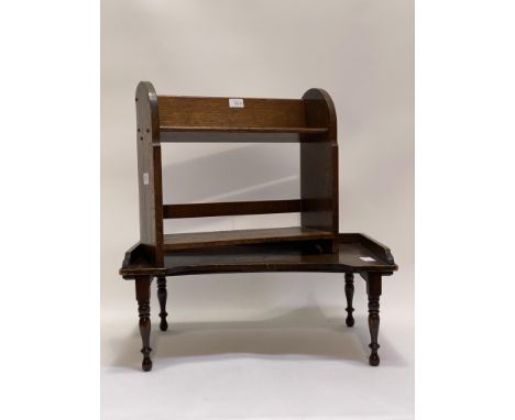 An early 20th century oak tabletop book trough with open shelf under, raised on arched panel end supports (H42cm) together wi