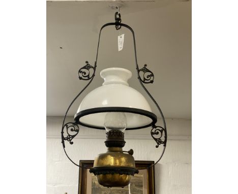 A Victorian wrought iron hanging kitchen oil / parafin lamp, with opeline glass domed shade. H70cm