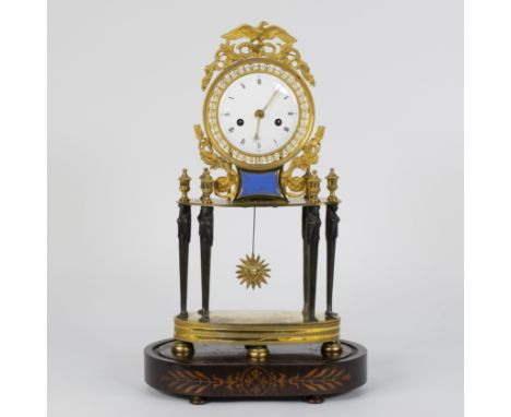 A so-called ‘Rotonde’ skeleton Empire clock of fire gilt bronze, enamel dial with Roman numerals and blue enamel plaque marke