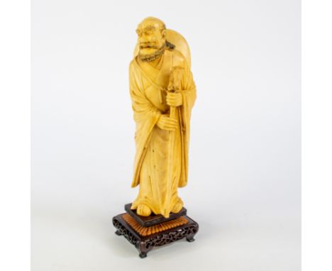 An ivory sculpture, representing an Archat (Arahant), a Buddhist who has reached the stage of enlightenent, holdingh a pelgri