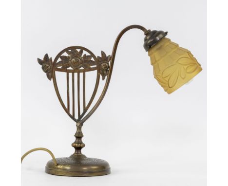 Art Nouveau lamp with bronzed brass  lamp base in the shape of a harp with roses and stylised leaves and shade in amber glass