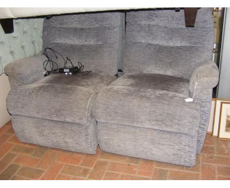 A two seater reclining sofa upholstered in grey 