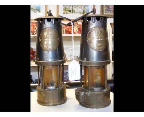 A pair of vintage miner's lamps, with badge impressed 'The Protector Lamp &amp; Lighting Co. Ltd.' 