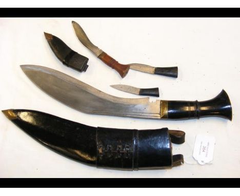 Post WWII Gurkha Kukri knife with leather scabbard together with a miniature one