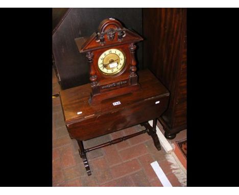 A wooden cased mantle clock together with a small drop leaf table