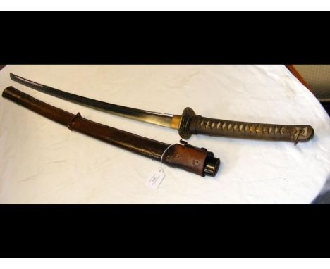 A Japanese sword Katana with 67cm curved single edge blade, having two Menuki, with lacquered scabbard and leather outer shea