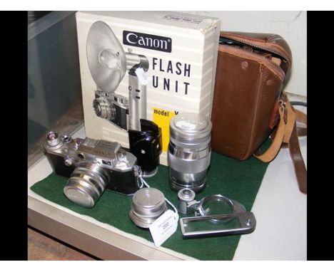 A vintage Canon No.156203 SLR Camera, together with vintage flash unit, lenses, etc. CONDITION REPORTAs per images