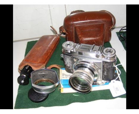 A vintage Voigtlander SLR Camera with carrying case and accessories 
