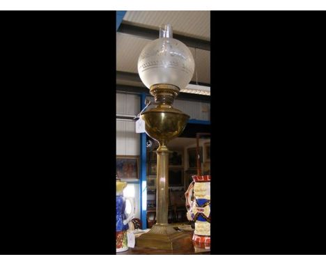 A Victorian brass oil lamp with glass shade