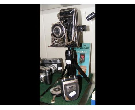 A vintage German camera on stand with light meter, etc. 