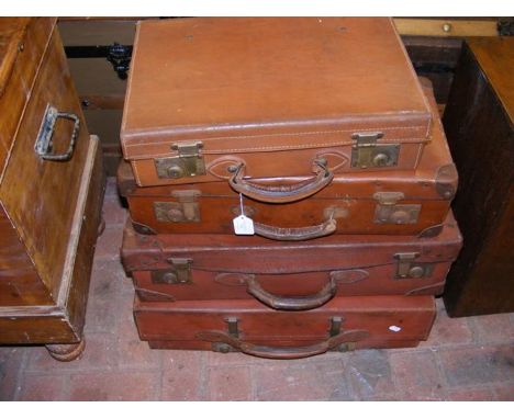 Four graduated leather vintage suitcases 