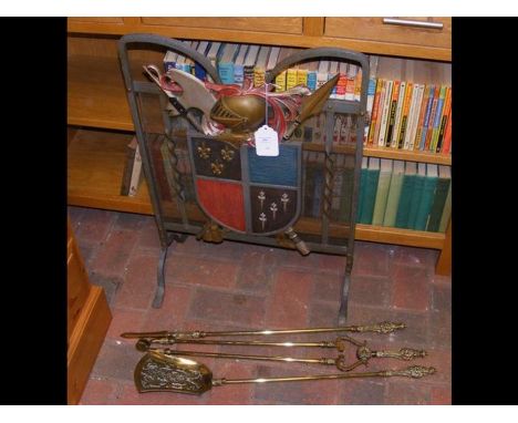 A 1930's armorial fireguard, together with a fire poker and other accessories 