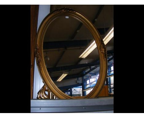 A gilt framed oval wall mirror 