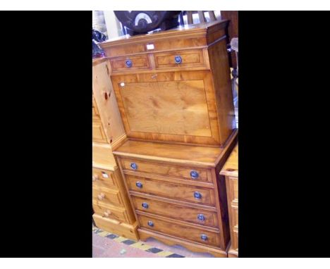 A reproduction yew wood secretaire chest with green inset leather to writing panel