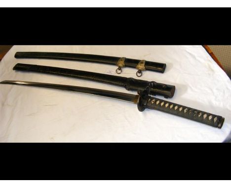 A Japanese sword Katana with 67cm curved single edge blade, having two Menuki, with lacquered scabbard and leather outer shea