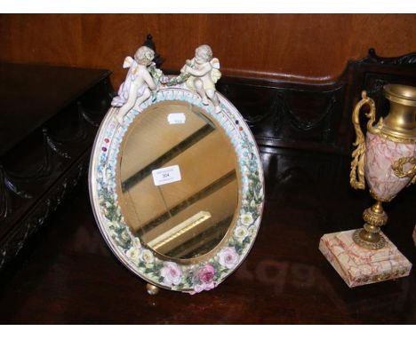 A decorative Dresden ceramic dressing table mirror with flower surround - 35cms