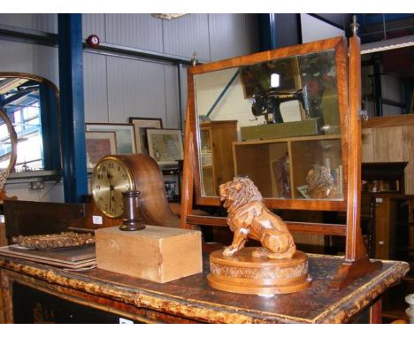 An eight day mantel clock, toilet mirror, abstract carved lion, etc. 