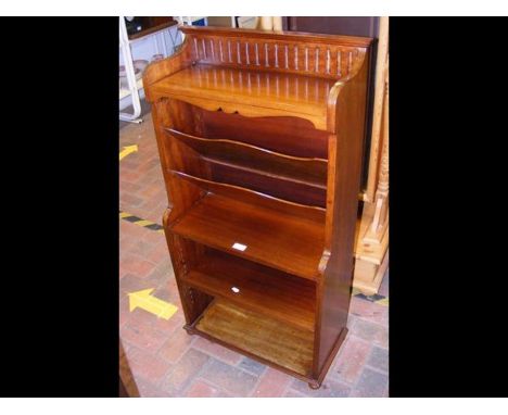 An antique mahogany magazine/book shelf