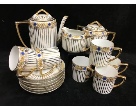 A Noritake Art Deco Coffee Service, decorated in gilt and enamels with laurel and blue jeweled banding over gilded fluting, c