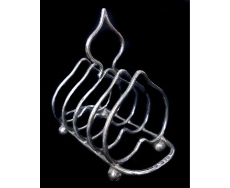A silver toast rack, the dividers of inverted heart shape on four ball feet, London 1902, makers mark W H & Ss Ld, for Willia