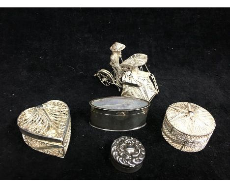 A white metal gaming counter box, set with two Chinese mother of pearl gaming counters; a circular silver pill box, repousse 