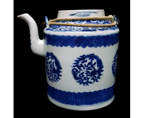 A Chinese blue and white porcelain teapot and cover, decorated with roundels of stylised dragons, wire and raffia double stra