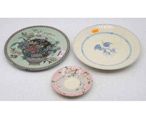 A Clarice Cliff plate on a cream ground, the centre enamel decorated with an urn issuing flowers, having printed 'Clarice Cli