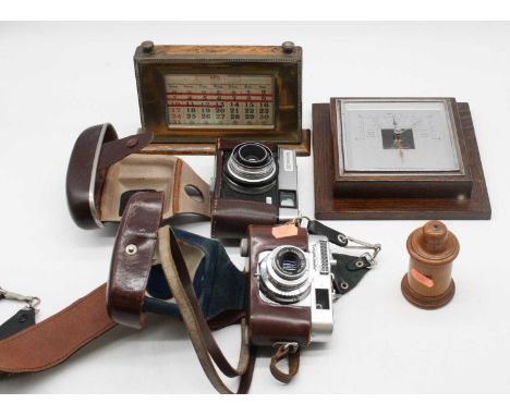 A collection of miscellaneous items to include an oak and brass mounted perpetual desk calendar, an oak cased barometer, Voig