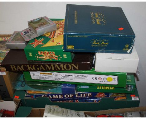 A collection of vintage board games to include Backgammon, Trivial Pursuit, and The Game of Life